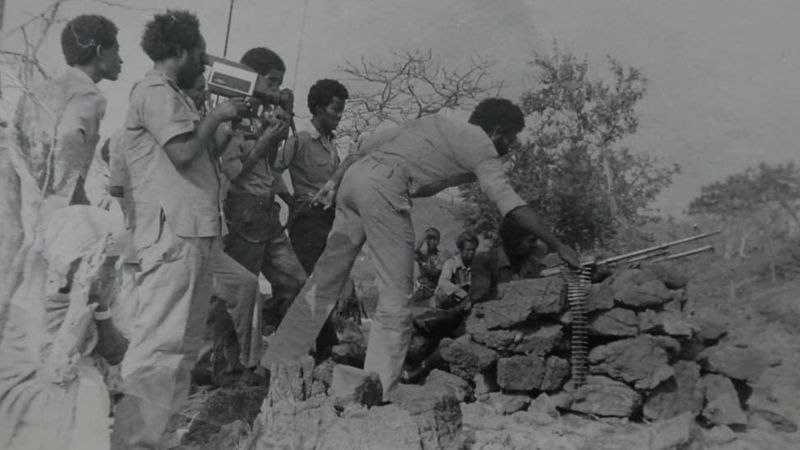 This image captures a moment during a film crew and journalists operating in a conflict zone